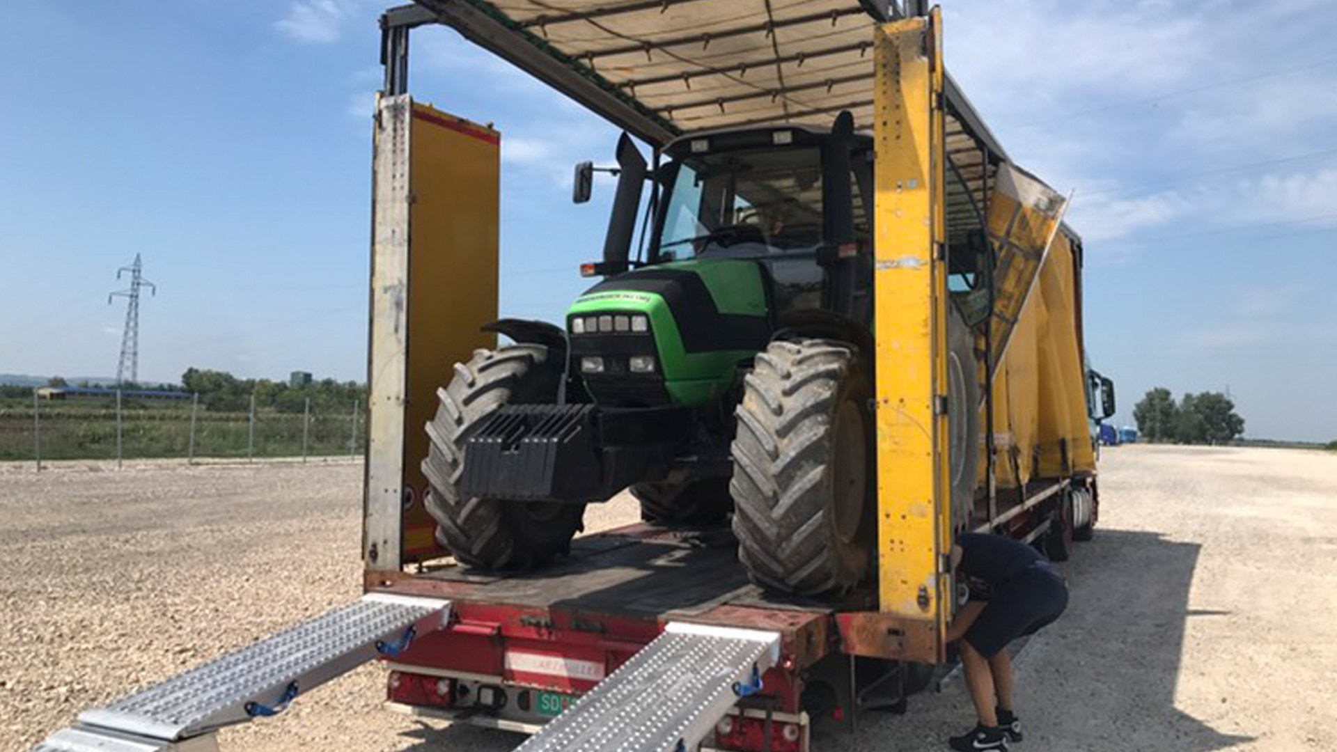 Traktor se uteruje u prikolicu preko rampi